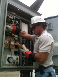 Gregory Lewis Jr from the University of South Alabama working at an Alabama Power substation checking out a Power Circuit Breaker.