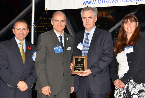 Ottawa Chapter Chair Wahab Almuhtadi, IEEE Canada President Amir Aghdam, and Ottawa Section Chair Janet Davis presenting the 2015 Outstanding Engineer Award plaque to Dr. Branislav Djokic at 2015 Ottawa Section AGM.